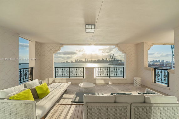 Balcony view overlooking a city skyline and water body.