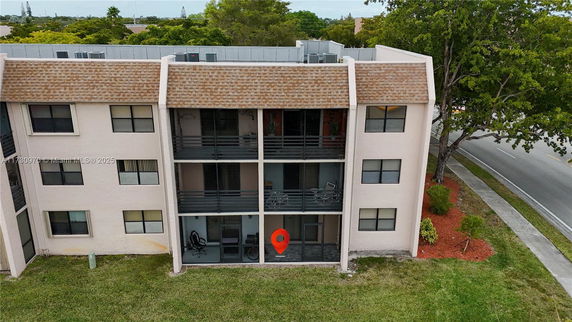 Front view of a multi-story residential building with balconies.