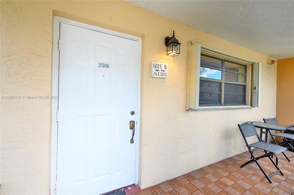 Front view of a house entryway with door and window.