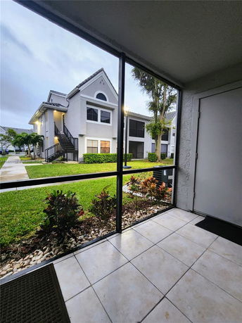 Front view of a two-story residential building with external staircase.