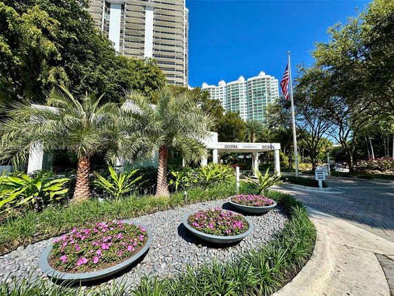 Front view of a multi-story building with landscaped entrance.