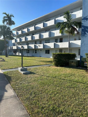 Front view of a multi-story residential building with balconies.