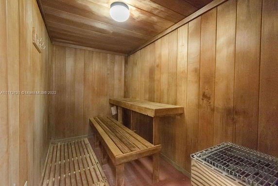 Interior view of a wooden sauna room with benches.