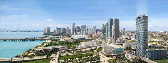 Panoramic view of a cityscape with high-rise buildings and a waterfront.