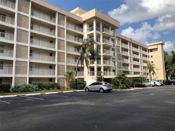 Front view of a multi-story residential building with balconies.
