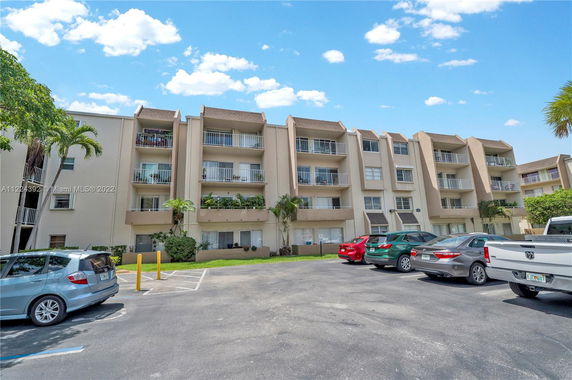 Front view of a multi-story apartment building with balconies.