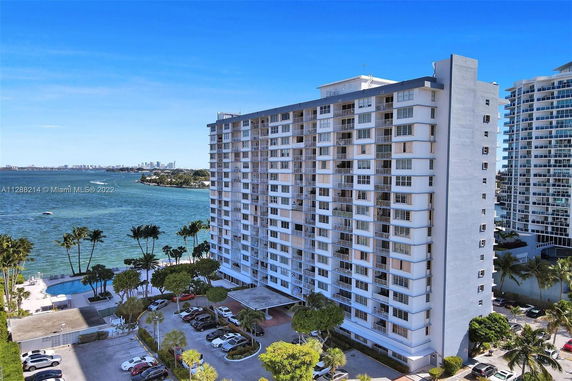Front view of a multi-story building beside the waterfront.