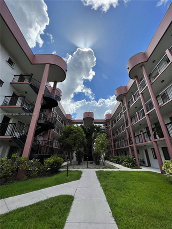 View of a multi-story apartment complex with curved balconies.