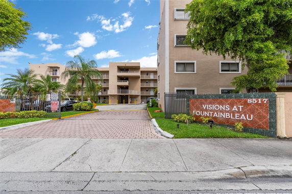 Front view of a multi-story residential building named Visions at Fountainbleau.
