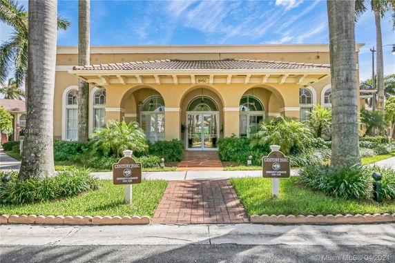 Front view of a one-story building with arched windows and entrance.