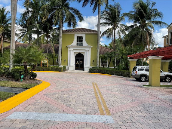 Front view of a building with a tiled roof and a grand entrance.