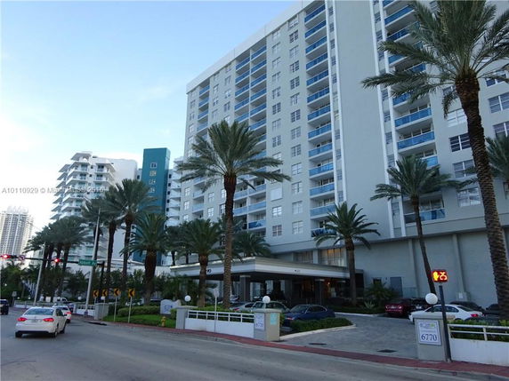 Front view of a multi-story residential building with balconies.