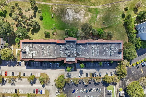 Aerial view of a building's rooftop with various equipment units visible.
