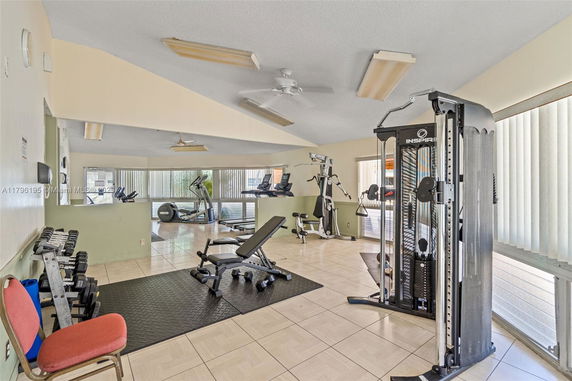 Indoor gym area with exercise equipment and workout benches.