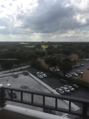 Panoramic view of a parking area and surrounding greenery from a high vantage point