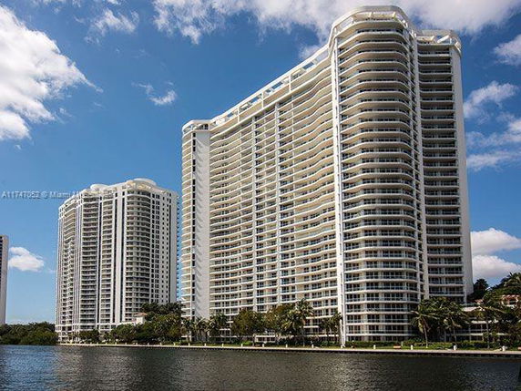 Front view of a high-rise residential building by the water.
