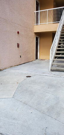 Front view of a building with an outdoor staircase.