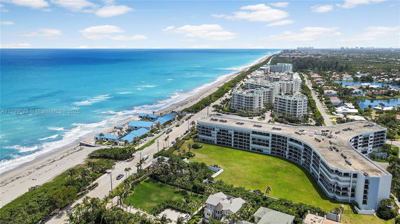 Aerial view of a coastal area with high-rise buildings and a beach along the ocean.