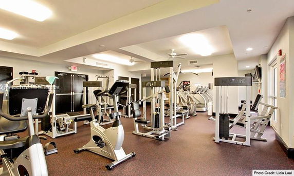 Interior view of a gym area with various exercise equipment.