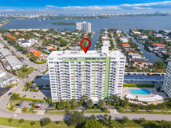 Front view of a multi-story apartment building with balconies.