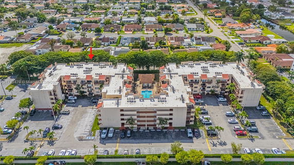 Aerial view of a large residential building complex with surrounding neighborhood.