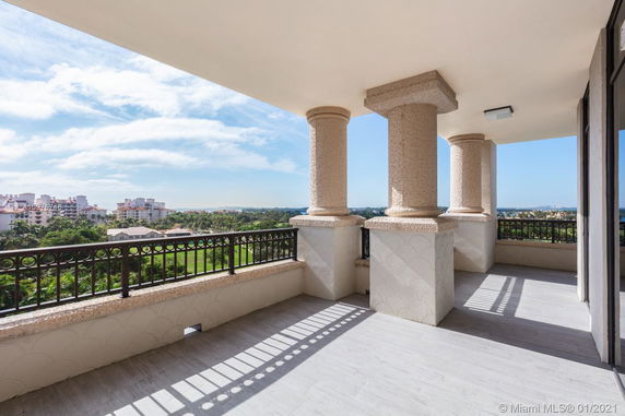 Elevated balcony with ornate pillars offering a scenic view of the surrounding area.