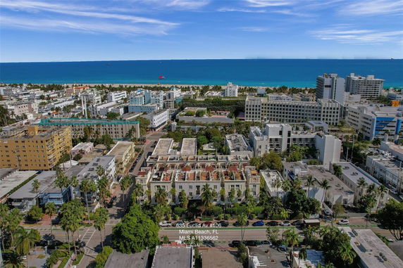 Aerial view of a coastal urban area with multiple buildings and the ocean in the background.