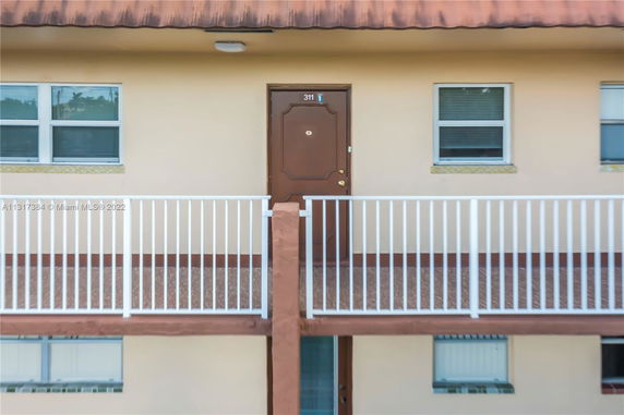 Front view of an apartment with a balcony railing and door number 311.