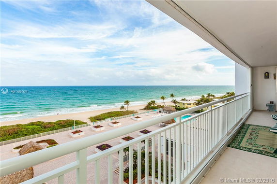 Panoramic view of a beachfront from a balcony.