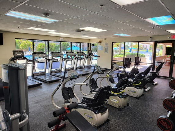 Interior view of a gym area with treadmills and exercise bikes.