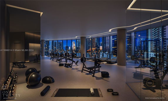 Interior view of a modern fitness area with gym equipment and large windows overlooking the city.