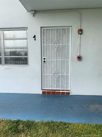 Front view of a building entrance with a metal security door.
