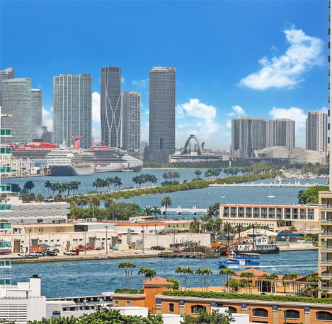 View of city skyline with tall buildings and waterways.