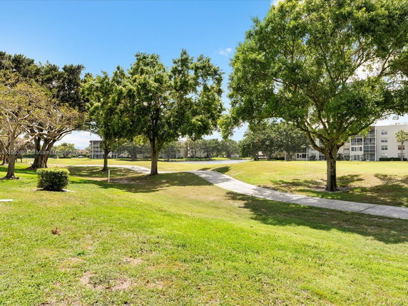 View of surrounding areas with trees and a pathway near a building.