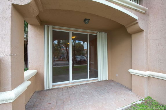 Front view of a building entrance with sliding glass doors.