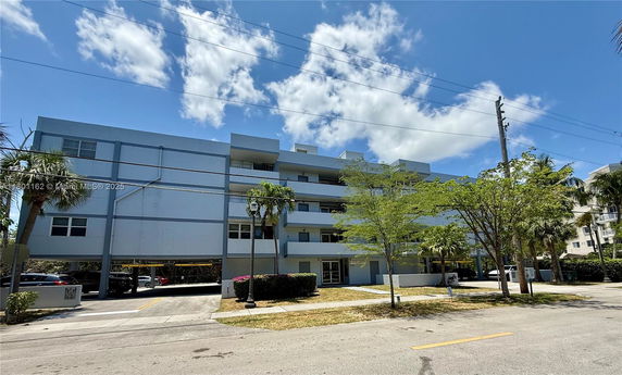 Front view of a multi-story residential building with balconies.