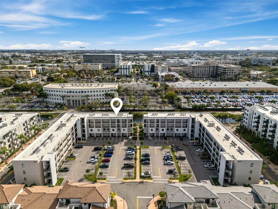 Panoramic view of a residential complex with multiple buildings and parking areas.