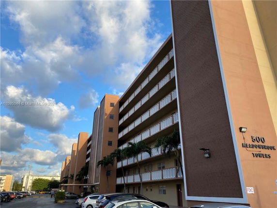 View of a multi-story building with a series of balconies, labeled as Meadowbrook Towers.