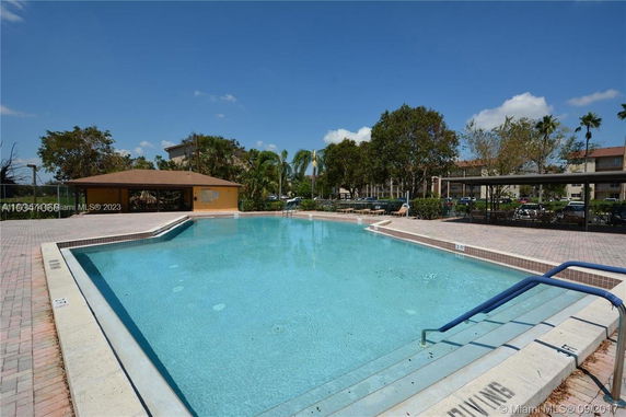 Outdoor swimming pool area with surrounding lounge space.