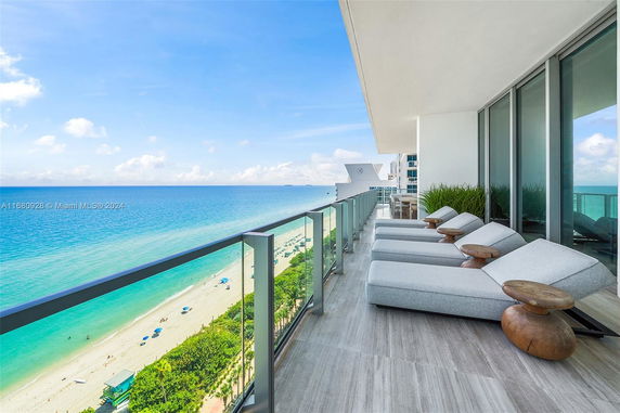 Panoramic view of a balcony overlooking the beach and ocean.