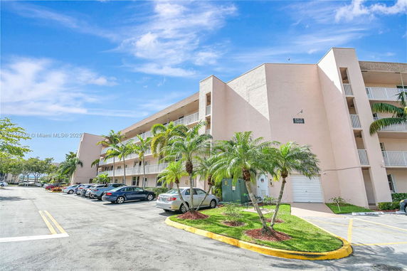 Front view of a multi-story residential building with balconies.