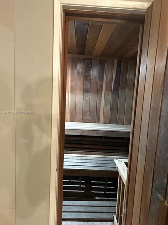 Interior view of a wooden sauna room with benches.