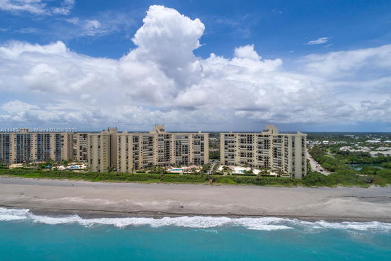 Front view of a large beachfront apartment complex with multiple stories.