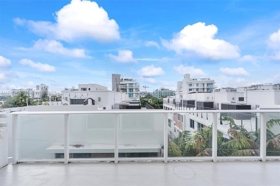 Wide angle view of surrounding residential buildings from a rooftop area.
