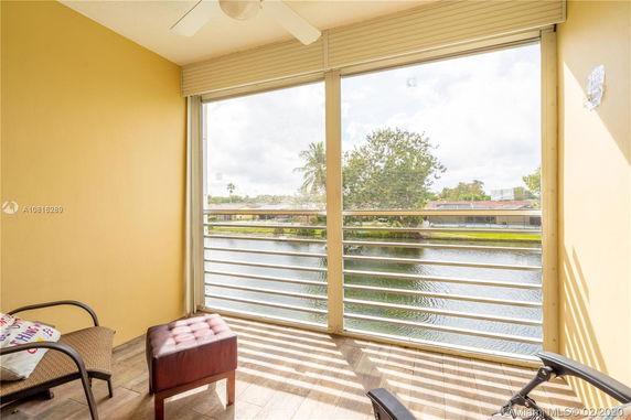 View from a balcony overlooking a body of water and surrounding greenery.