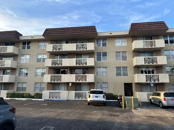 Front view of a multi-story residential building with balconies.
