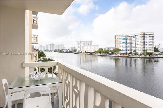 Balcony view overlooking water and nearby buildings.