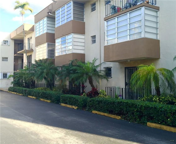 Front view of a multi-story residential building with balconies.