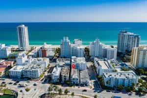 Aerial view of a coastal cityscape with high-rise buildings near the beach.