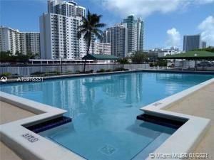 View of a swimming pool with high-rise buildings in the background.